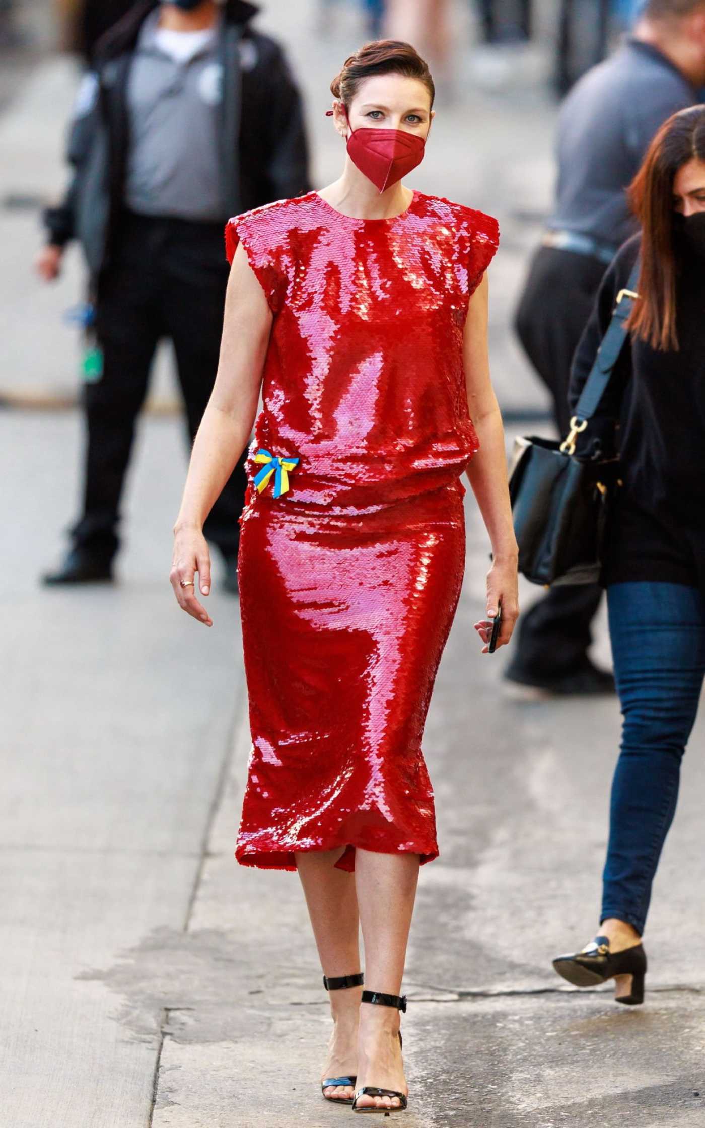 Caitriona Balfe in a Red Dress Arrives at Jimmy Kimmel Live in Los Angeles 03/02/2022