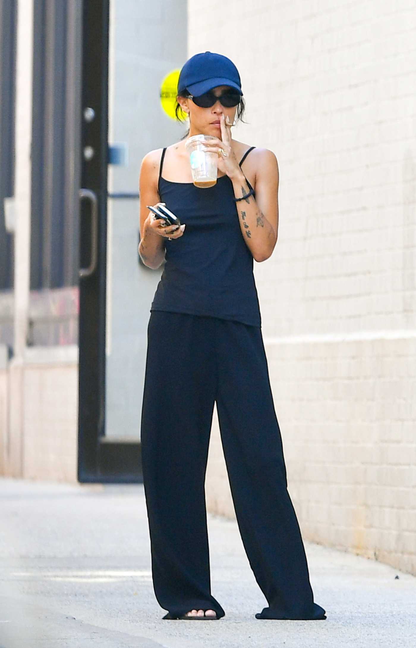 Zoe Kravitz in a Blue Cap Was Spotted Taking a Smoke Break in New York City 08/24/2022