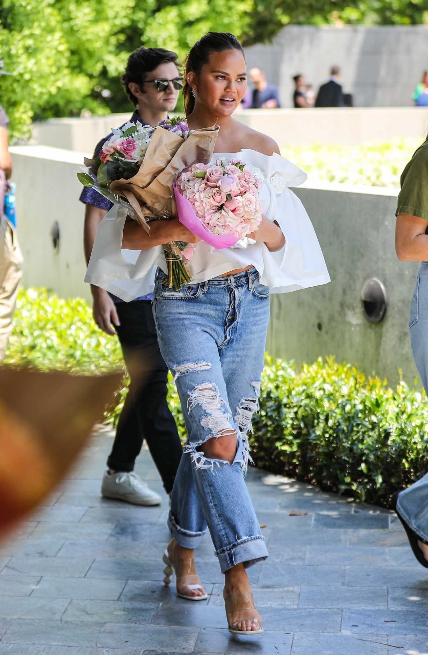 Chrissy Teigen in a Blue Ripped Jeans Was Seen Out in Los Angeles 06/03/2023
