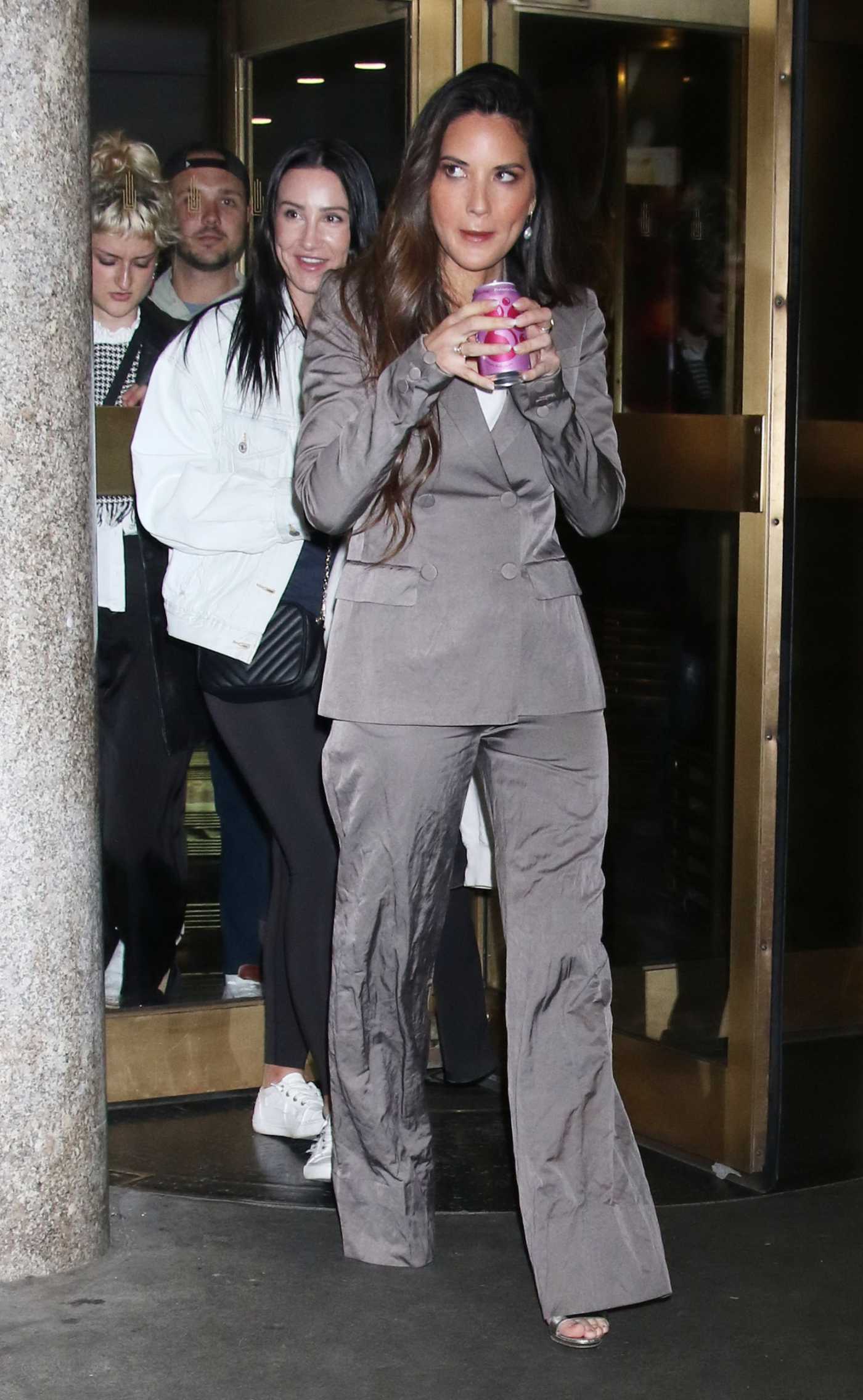Olivia Munn in a Grey Pantsuit Leaves the Kelly Clarkson Show in New York 04/23/2024