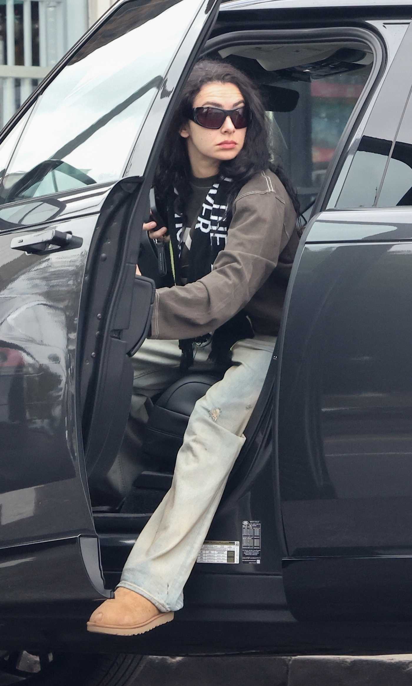 Charli XCX in a Blue Ripped Jeans Arrives at All Time in Los Angeles 04/16/2025