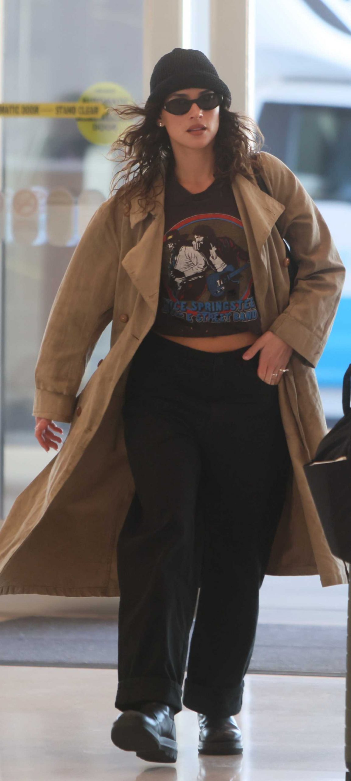 Adria Arjona in a Beige Trench Coat Arrives at LAX Airport in Los Angeles 10/21/2026